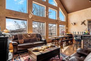 Living room featuring a high ceiling and hardwood / wood-style floors