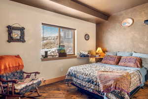 Bedroom with baseboards and hardwood / wood-style flooring