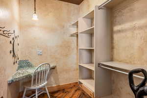Spacious closet featuring hardwood / wood-style flooring