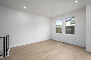 Unfurnished room with recessed lighting and light wood-type flooring