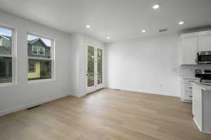 Unfurnished dining area featuring recessed lighting and light wood-type flooring