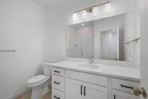 Full bath featuring vanity and a shower stall