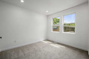 Spare room with carpet floors and recessed lighting