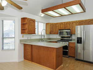 Oak Kitchen with Corian Counters & Stainless Appliances