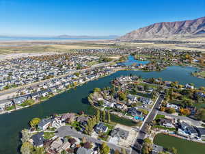 Aerial view of property's location featuring nearby suburban area and a water and mountain view