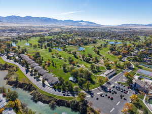 Aerial perspective of suburban area with a water and mountain view and a golf club