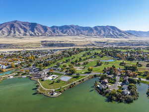 View of property location featuring a water and mountain view and nearby suburban area