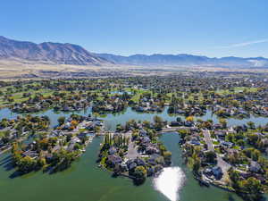 View of property location featuring nearby suburban area and a water and mountain view