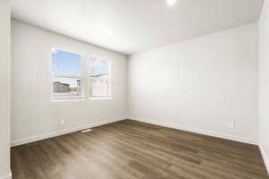 **DISCLAIMER- exterior and interior options will vary**Unfurnished room with dark wood-style flooring and recessed lighting