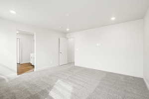 **DISCLAIMER- exterior and interior options will vary**Unfurnished bedroom featuring light carpet, recessed lighting, and connected bathroom