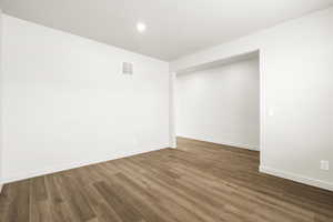 Spare room with wood finished floors and recessed lighting