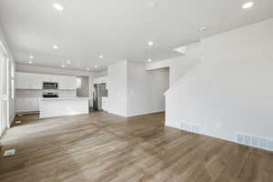 **DISCLAIMER- exterior and interior options will vary**Unfurnished living room featuring recessed lighting and light wood-type flooring