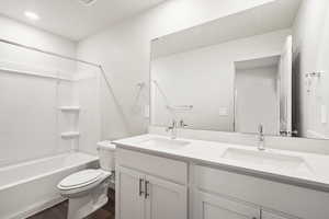 **DISCLAIMER- exterior and interior options will vary**Full bath with double vanity, shower / bath combination, and dark wood-type flooring