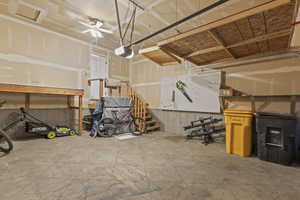 Garage with a garage door opener and ceiling fan