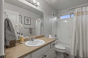 Full bathroom featuring vanity and shower / bath combination with curtain