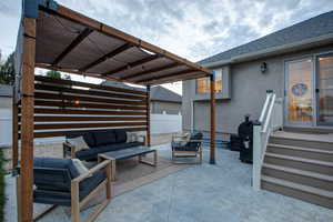 View of patio featuring outdoor lounge area and a pergola