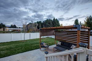 Fenced backyard featuring a patio area and an outdoor living space