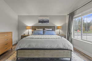 Bedroom featuring baseboards and wood finished floors
