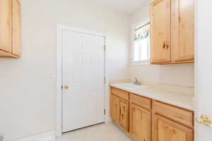 Kitchen featuring light brown cabinetry, light countertops, and light tile patterned floors