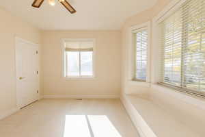 Empty room featuring carpet floors and ceiling fan
