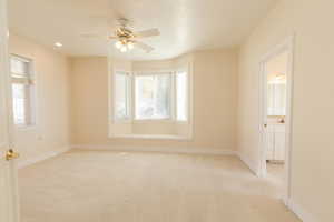 Empty room featuring light carpet, ceiling fan, and recessed lighting