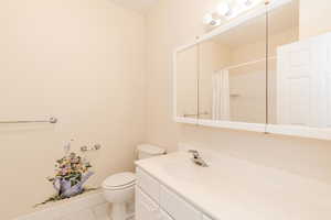 Bathroom with light tile patterned floors, vanity, and curtained shower