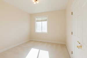Unfurnished bedroom with baseboards and light carpet