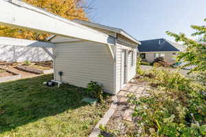 View of outbuilding with a garden
