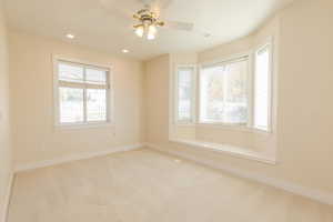 Spare room featuring carpet, recessed lighting, and a ceiling fan