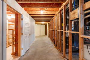 Unfinished below grade area featuring water heater