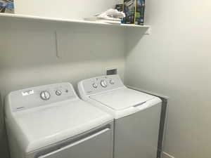 Laundry room featuring washer and clothes dryer