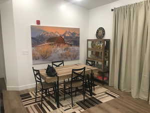 Dining room with wood finished floors and baseboards