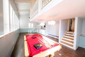 Recreation room featuring dark wood-type flooring, a ceiling fan, and pool table