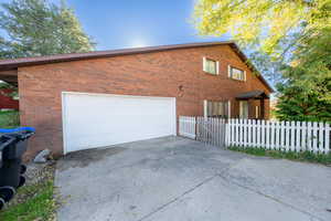 View of side of property with brick siding and driveway