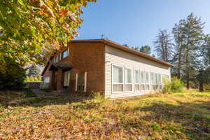 View of side of property with brick siding