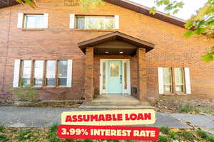 Doorway to property with brick siding