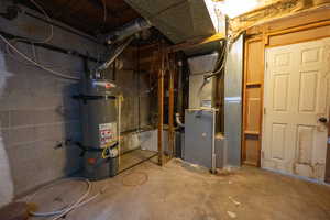 Utility room with strapped water heater and heating unit
