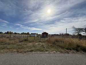 View of yard featuring a rural view and an outdoor structure