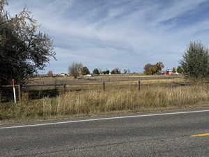 View of asphalt road with a rural view