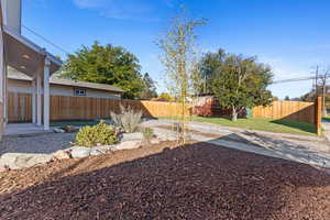 Fenced backyard with a patio