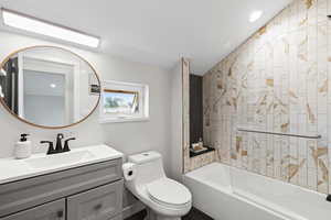 Full bath with tub / shower combination, vanity, and recessed lighting