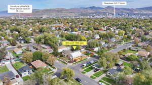 Aerial view of property's location with mountains and nearby suburban area