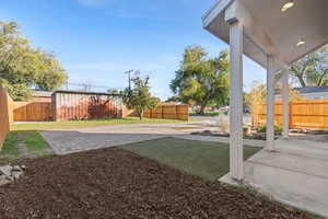 Fenced backyard with a patio area