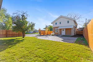 Back of property with a fenced backyard and board and batten siding
