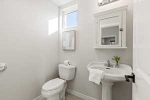 Bathroom with baseboards and tile patterned floors