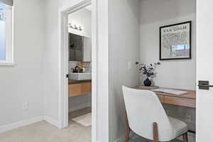 Home office with a sink and built in desk