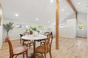 Dining area with light wood-style flooring, recessed lighting, and plenty of natural light