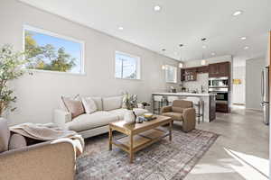 Living room with concrete flooring and recessed lighting