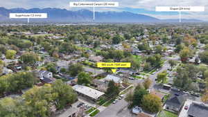 Aerial view of property's location with nearby suburban area and a mountainous background