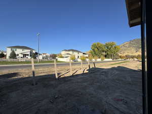 View of yard with a residential view. fence also under construction